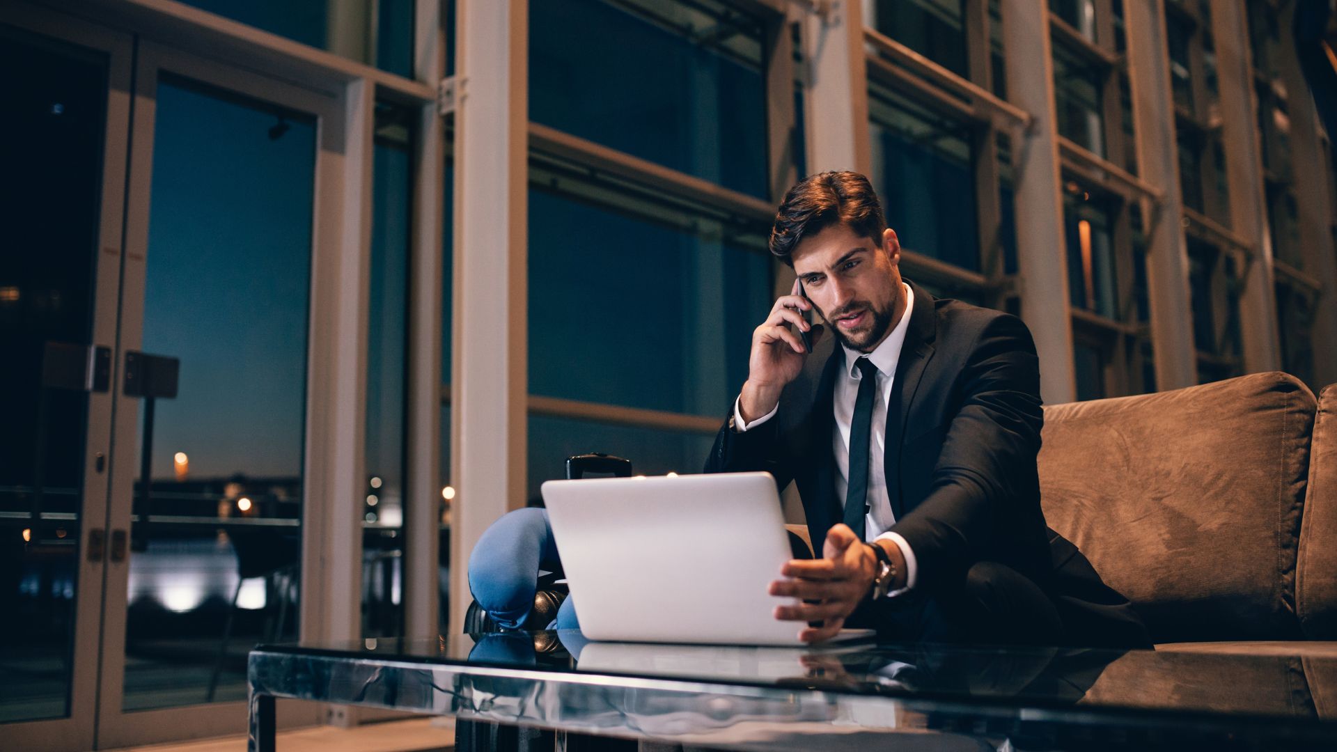 Customer reviewing charter quotes on a tablet inside a private airport lounge.